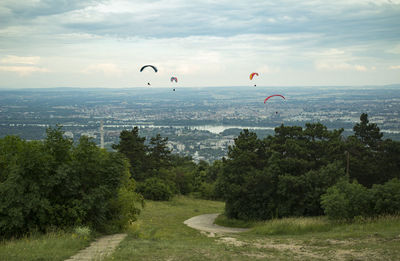 People paragliding against sky