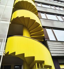 Low angle view of modern building against sky and a staircase. 
