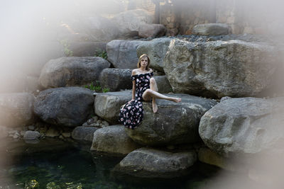 Woman sitting on rock