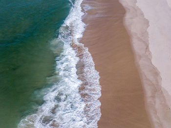 High angle view of waves on beach