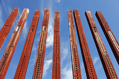 Low angle view of metallic structure against blue sky