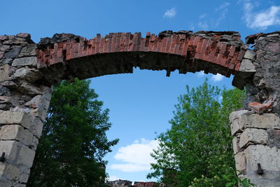 Low angle view of old ruins against blue sky