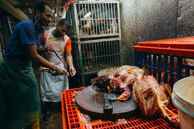 Man working on barbecue grill at market