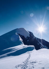 Scenic view of snow mountains against sky