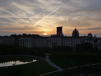 Bridge over river against buildings in city