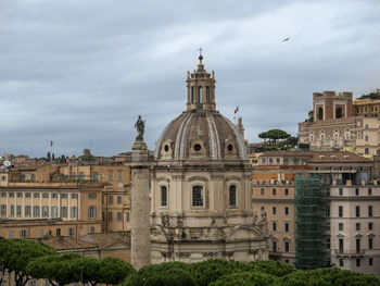 Buildings against cloudy sky