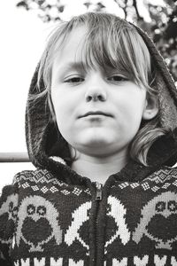 Low angle portrait of girl wearing sweater with hood