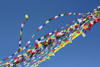 Low angle view of prayer flags against clear sky