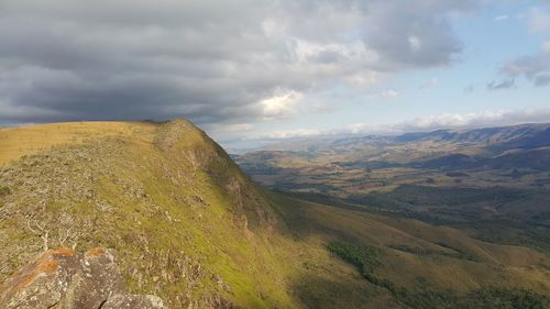 Scenic view of mountains against cloudy sky