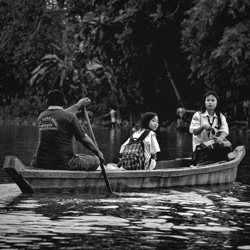 water, full length, leisure activity, person, lifestyles, tree, sitting, casual clothing, childhood, boys, young adult, waterfront, lake, day, human representation, animal representation, art, happiness