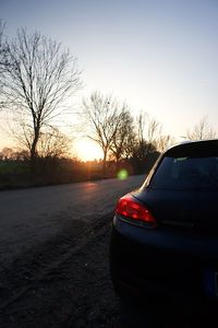 Car on road against sky during sunset