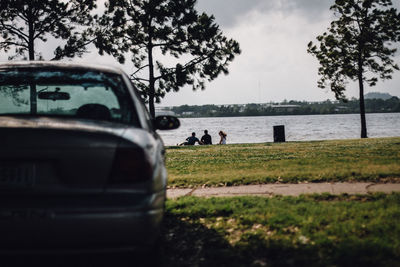 Car by sea against sky