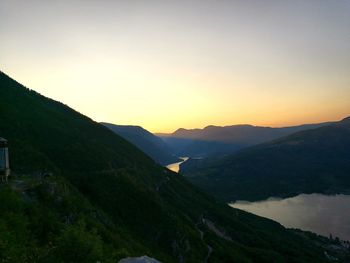 Scenic view of silhouette mountains against sky during sunset