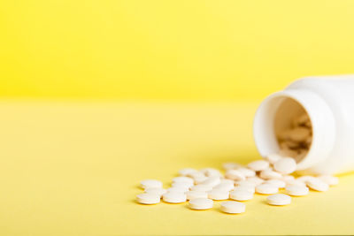 Close-up of pills against yellow background