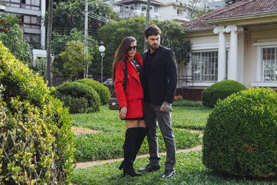 Full length of young couple standing in park