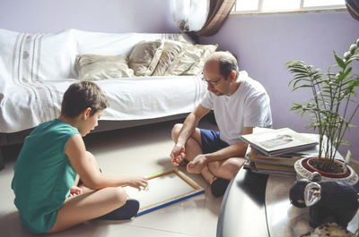 Father and child son playing glazing balls at home. happy home concept. salvador, bahia, brazil.