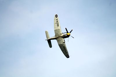 Low angle view of airplane flying against clear sky