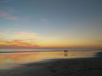 Scenic view of beach against sky during sunset