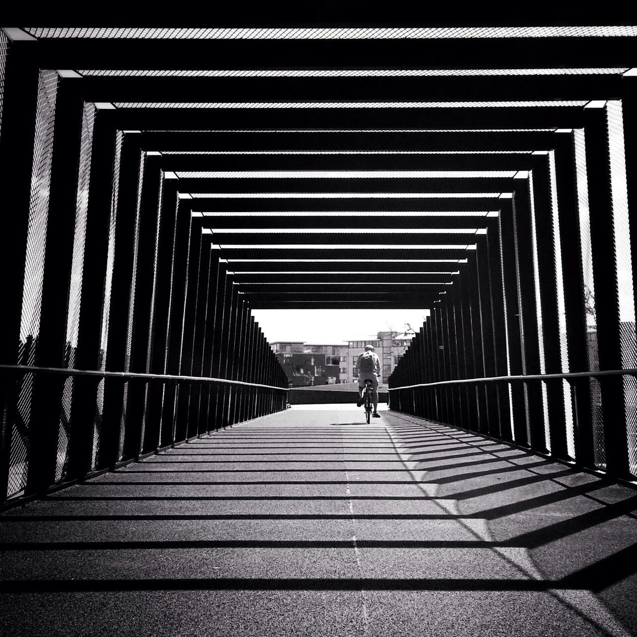 the way forward, diminishing perspective, architecture, vanishing point, built structure, walking, railing, transportation, incidental people, in a row, city, building exterior, walkway, street, day, pedestrian walkway, outdoors, footbridge, city life