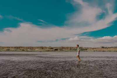 Side view of woman walking on sand
