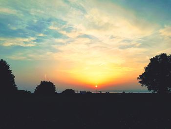 Scenic view of silhouette landscape against sky at sunset