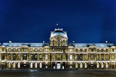 Low angle view of illuminated pavillion de horloge of the louvres museum in paris france at night