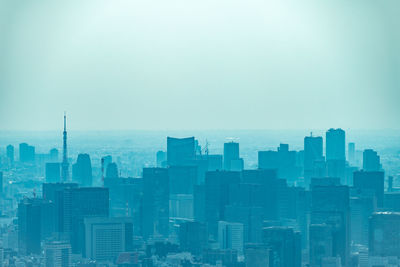 Buildings in city against clear sky