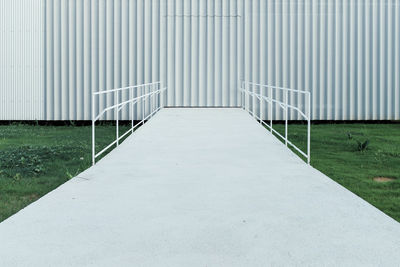 Footbridge leading towards corrugated iron