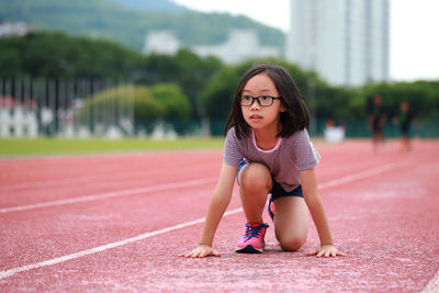 Cute girl on running track