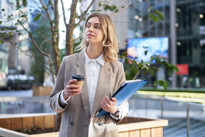 Portrait of young woman using mobile phone