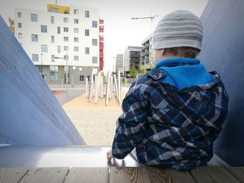 Midsection of man using mobile phone in city