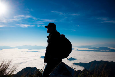 Silhouette man looking at mountain against sky