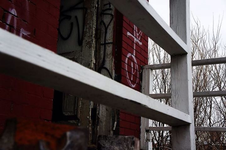 architecture, built structure, building exterior, window, residential structure, residential building, building, house, city, red, low angle view, day, outdoors, brick wall, no people, wall - building feature, abandoned, weathered, text, graffiti