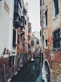 Buildings by canal in city