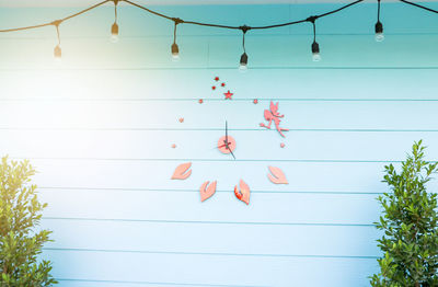 Low angle view of decoration hanging on tree against sky