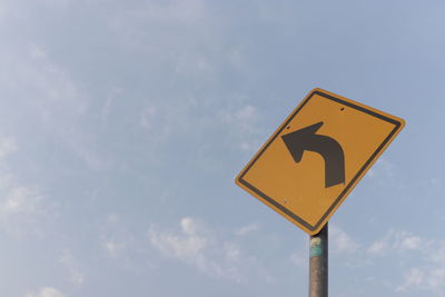 Low angle view of road sign against sky