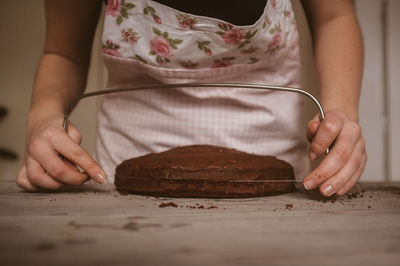 Woman cutting cake in half