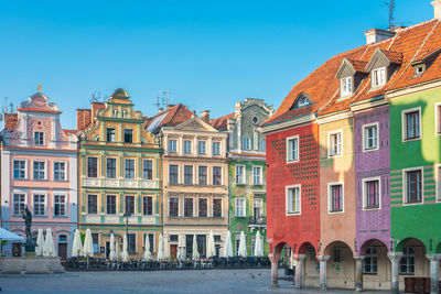 Buildings in city against blue sky