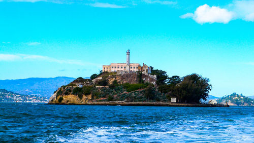 Building by sea against sky