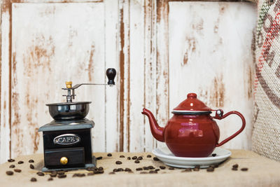 Close-up of tea cup on table against wall