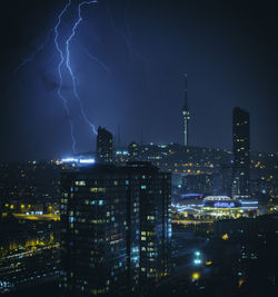 Aerial view of illuminated city against sky at night