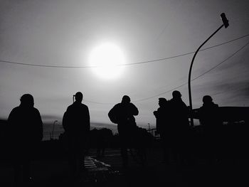 Low angle view of silhouette people against sky