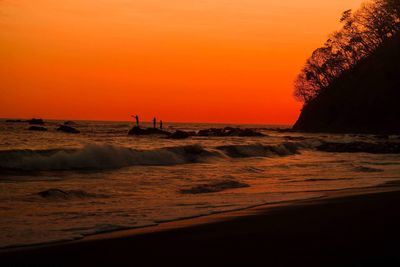 Scenic view of sea against orange sky