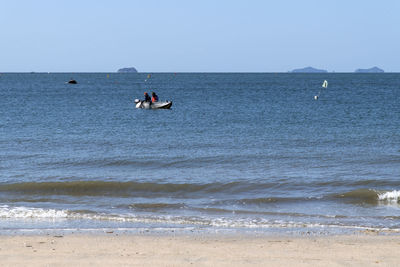 People on beach against sky