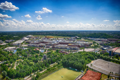 High angle view of townscape by sea against sky