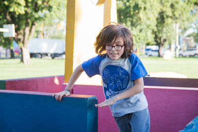 Portrait of child running in playground labyrinth