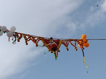 Low angle view of dahi handi decorations against sky