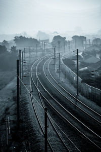 Railroad tracks against sky during winter