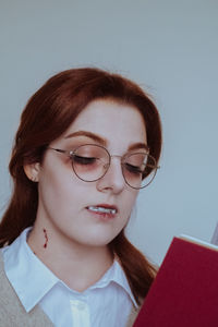 Portrait of young woman using mobile phone