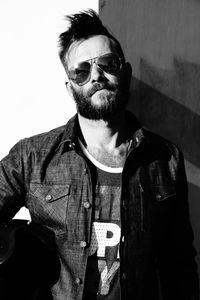 Portrait of man wearing sunglasses standing outdoors